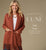 Model on tan background. Wearing a cardigan with fringe featuring Heavenly-Luxe collection.