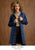 Model on brown textured background promoting chic layers collection wearing a blue denim jacket.