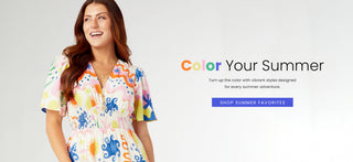 Model wearing a colorful printed dress on a grey background.