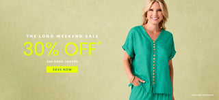 A woman wearing a teal green short-sleeve button-front top stands against a textured light olive background with promotional sale text on the left reading 'The Long Weekend Sale 30% Off' and a yellow 'Save Now' button.