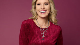 Model wearing red top on pink background