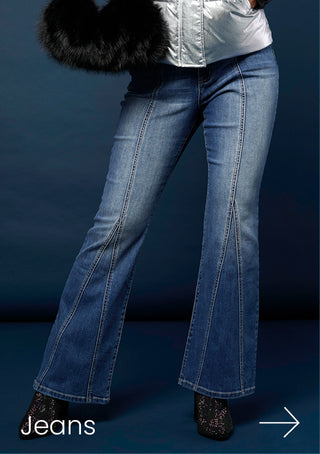 Model wearing blue jeans on blue background.