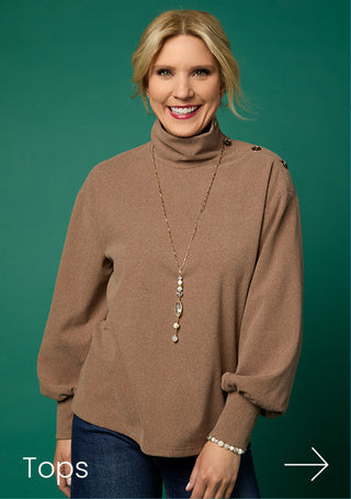 Model wearing brown top on green background.