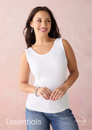 Woman wearing a white tank top and blue jeans against a pink background