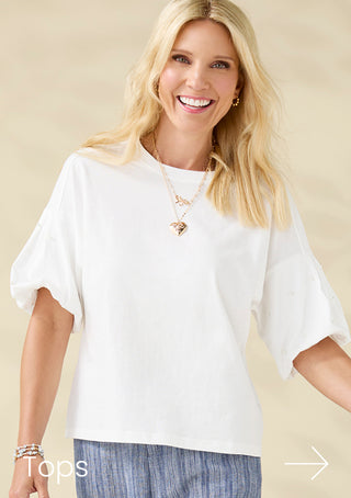 Woman wearing a white top with a beige background