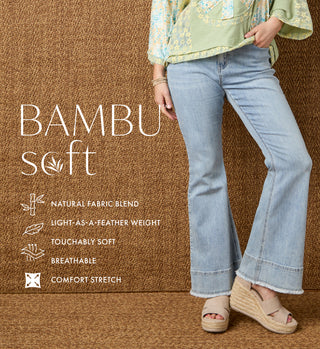 Person wearing light blue jeans with promotional text about 'BAMBU soft' fabric on a brown background