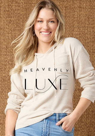 Woman wearing a beige hoodie with 'Heavenly Luxe' text against a textured brown background